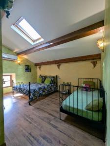 a bedroom with two bunk beds and a skylight at Chambres D'hôtes - Au Soleilo in Mostuéjouls +57 photos