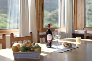 a bottle of wine sitting on a table with a glass at Vivienda Vacacional Risco Blanco in San Bartolomé