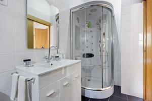a bathroom with a sink and a shower at Casa Do Riacho - Douro in Armamar +28 photos