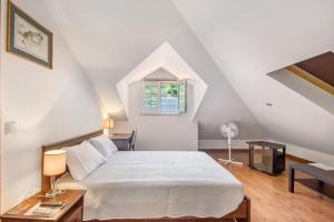 a bedroom with a large bed in a attic at Casa Do Riacho - Douro in Armamar