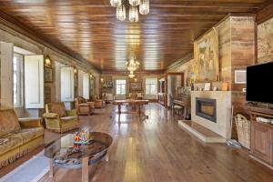 a living room filled with furniture and a fireplace at Casa Do Riacho - Douro in Armamar