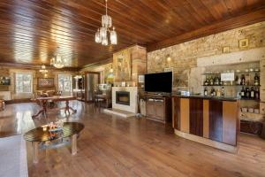a large living room with a bar and a tv at Casa Do Riacho - Douro in Armamar