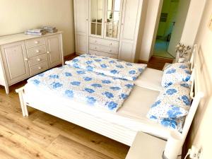 a bedroom with a bed with blue and white pillows at Ferienappartement - Haus am See in Woltersdorf