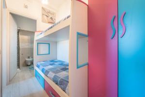 a kids bedroom with a bunk bed and a staircase at Gemma Piccolino in Villasimius