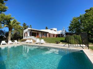 a swimming pool in front of a house at Bon Viure in Marratxí 
