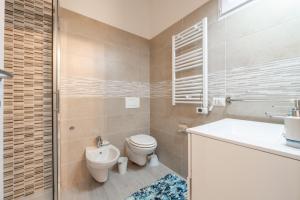a bathroom with a toilet and a sink at Gemma Piccolino in Villasimius +13 photos