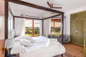 a bedroom with a large white bed with a large window at Bon Viure in Marratxí  +20 photos