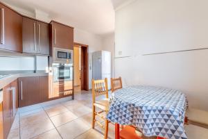 a kitchen with a table and a kitchen with a table and chairs at Caril in Binissalem