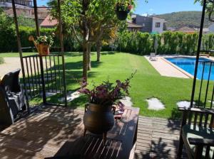 a patio with a vase of flowers on a table at Solar de Rabal in Bragança