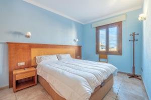 a bedroom with a large bed and a window at Caril in Binissalem