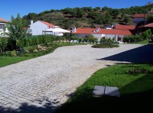 a cobblestone walk way in a yard with houses at Solar de Rabal in Bragança