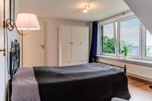 a bedroom with a bed and a window at Haus Seeblick in Langballig