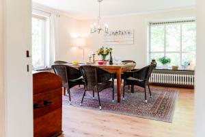 a dining room with a table and chairs at Haus Seeblick in Langballig