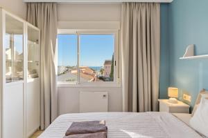 a bedroom with a bed and a large window at Topacio A114 in Mijas Costa +15 photos