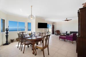 a dining room and living room with a table and chairs at House Carla Private Pool Heated in Puerto de Santiago