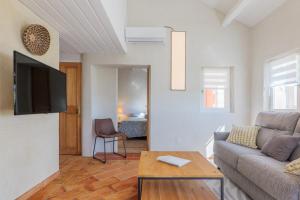 a living room with a couch and a table at Le Barry in Tulette