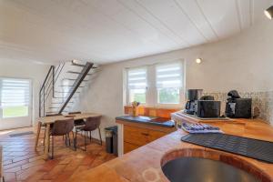 a kitchen with a counter and a table with chairs at Le Barry in Tulette