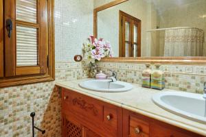a bathroom with a sink and a mirror at Cortijo Rural Majolero 3 in Castillo de Locubín +28 photos