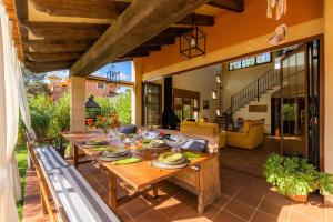 an outdoor dining room with a wooden table and chairs at Estrella in Son Serra de Marina