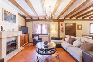 a living room with a couch and a fireplace at Casa el Arroyal in Rades de Abajo