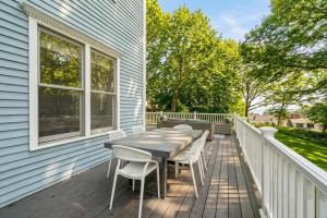 a wooden deck with a table and chairs on a house at 3 Mins to York Beach Large Deck Water View in York