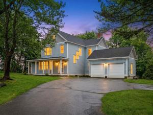 a large house with a garage in front of it at 3 Mins to York Beach Large Deck Water View in York