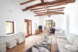 a living room with a couch and a table at Villa Can Rafal Ibiza in Sant Josep de sa Talaia