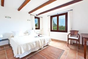 a bedroom with a bed and a desk and a chair at Villa Can Rafal Ibiza in Sant Josep de sa Talaia +37 photos
