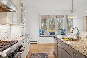 a kitchen with white cabinets and a counter top at 3 Mins to York Beach Large Deck Water View in York