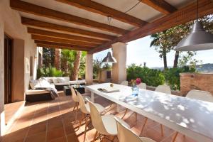 an outdoor living room with a table and chairs at Villa Can Rafal Ibiza in Sant Josep de sa Talaia