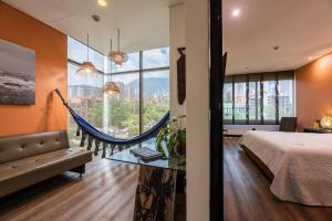 a bedroom with a bed and a hammock at Diez Hotel Categoría Colombia in Medellín +85 photos