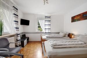 a living room with two beds and a couch at Ferienwohnung Sonnendeck in Laupheim