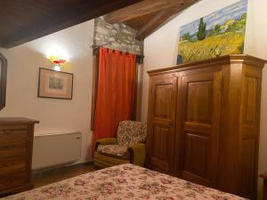 a bedroom with a bed and a chair at Casa dell'uliveto in Albettone