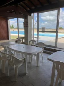 a table and chairs with a view of a pool at Chez Bilhouet in Segonzac