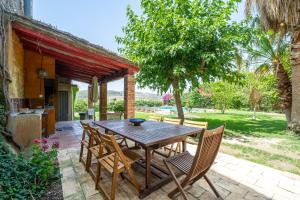 a wooden table and chairs on a patio at Bonastre in Bonastre