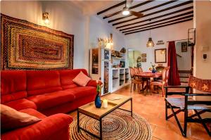 a living room with a red couch and a table at Amarilla in Callosa d'en Sarrià