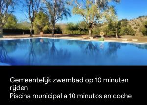a picture of a swimming pool with the wordsustainable zwolnomed up at Amarilla in Callosa d'en Sarrià