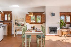 a kitchen with a table and stools in a room at Casa Belmonte in Bubión