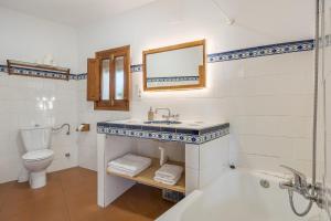 a bathroom with a sink and a toilet and a tub at Casa Belmonte in Bubión +20 photos