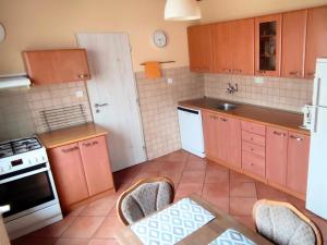 a kitchen with orange cabinets and a white door at Vila Caba in Křemže