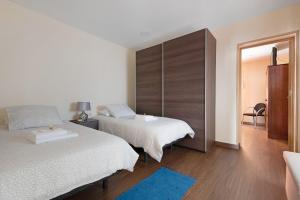 a bedroom with two beds and a mirror at Casa Margarita in La Guancha +27 photos