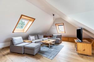 a living room with a couch and a tv at Ferienhaus Herich in Nieblum
