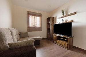 a living room with a flat screen tv and a couch at Casa Margarita in La Guancha