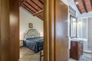a bedroom with a bed and a sink in a room at Il Campo Comfort apt with balcony in Siena