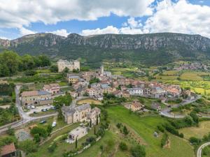 an aerial view of a town with mountains in the background at Chambres D'hôtes - Au Soleilo in Mostuéjouls