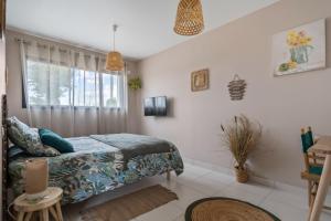 a bedroom with a bed and a window at Les loges de Pérelle in Chozeau