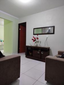 a living room with two couches and a flat screen tv at Flats Xingó in Piranhas