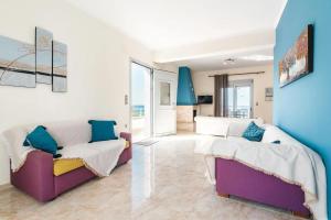 a living room with two beds and a couch at Blue Pearl Apolakkia in Apolakkiá