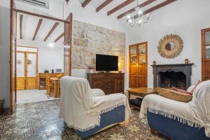 a living room with two chairs and a fireplace at La casa de la Sariera in Jávea