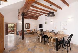 a kitchen and dining room with a wooden table and chairs at Las Rocas in Fornalutx